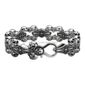 Mens sterling silver skull and fleur-de-lis bracelet, angled detail view of skull motif and panels