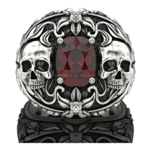 Mens oxidized silver dual skull ring with garnet center and filigree border